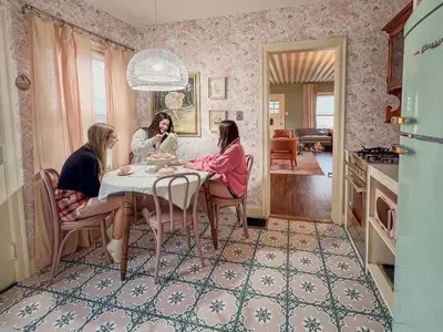 three women sitting around a table in a room at Peaches and Cream Coffee and Confetti Villa in Dayton
