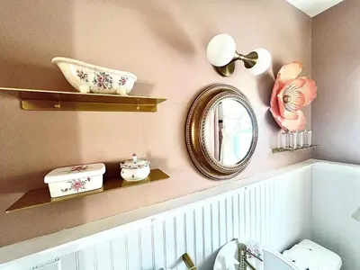 a bathroom with a mirror on a wall at Peaches and Cream Coffee and Confetti Villa in Dayton