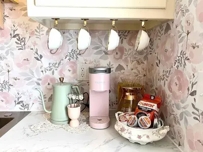 a kitchen with pink floral wallpaper and a blender on a counter at Peaches and Cream Coffee and Confetti Villa in Dayton
