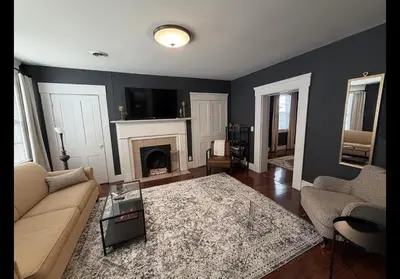 a living room with a couch and a fireplace at The Study in Chillicothe