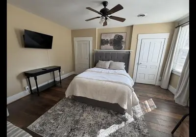 a bedroom with a bed and a ceiling fan at The Study in Chillicothe