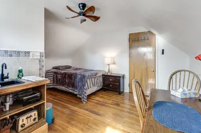 a bedroom with a bed and a ceiling fan at 3 Mi to UD and Kettering Health! Suburban Stay in Dayton