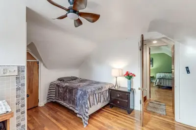 a bedroom with a bed and a ceiling fan at 3 Mi to UD and Kettering Health! Suburban Stay in Dayton