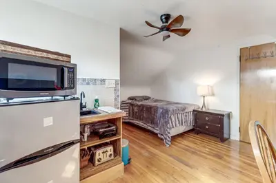 a bedroom with a bed and a ceiling fan at 3 Mi to UD and Kettering Health! Suburban Stay in Dayton