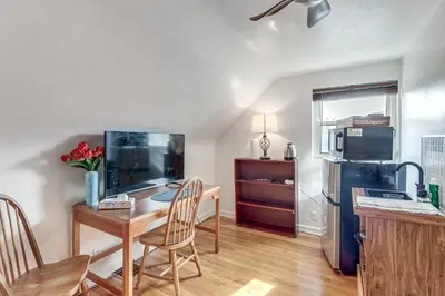 a kitchen with a table and a refrigerator at 3 Mi to UD and Kettering Health! Suburban Stay in Dayton