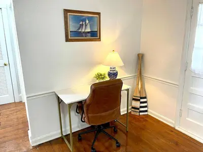 a desk with a lamp and a chair in a room at Coastal Cape Cod w/ King Bed, Game Room, & Bikes! in Vermilion