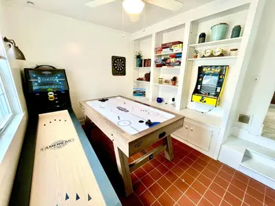 a room with a video game machine and a table at Coastal Cape Cod w/ King Bed, Game Room, & Bikes! in Vermilion