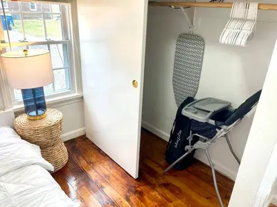 a room with a bedroom with a bed and a suitcase at Coastal Cape Cod w/ King Bed, Game Room, & Bikes! in Vermilion