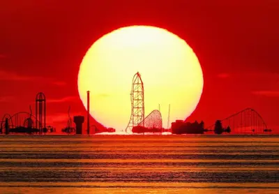 a red sunset with a roller coaster in the ocean at Coastal Cape Cod w/ King Bed, Game Room, & Bikes! in Vermilion