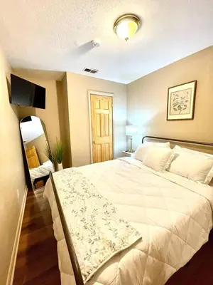 a bedroom with a large bed and a television at Vintage, Mid-Century Suite above Antique Store in Wakeman