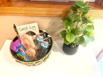 a basket of bread and a potted plant on a counter at Spacious King Bed Suite at Antique Store in Wakeman