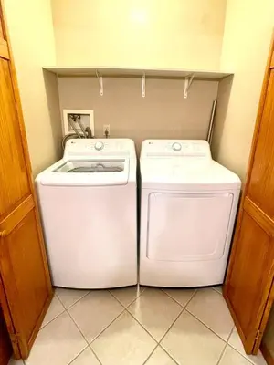 a laundry room with a washer and dryer at Spacious King Bed Suite at Antique Store in Wakeman