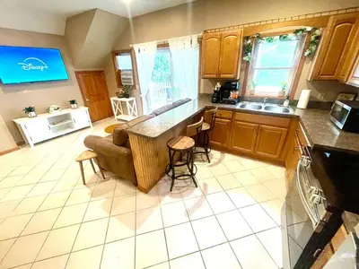 a kitchen with a couch and a counter top at Spacious King Bed Suite at Antique Store in Wakeman