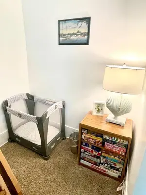 a room with a chair and a table with a lamp at ENTIRE UNIT- Charming Century Home in Harbour Town in Vermilion