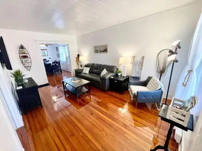 a living room with a couch and a table at ENTIRE UNIT- Charming Century Home in Harbour Town in Vermilion