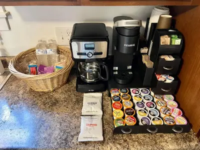 a counter with a coffee maker and some cupcakes and a coffeemaker at ENTIRE UNIT- Charming Century Home in Harbour Town in Vermilion