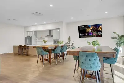 a kitchen and dining room with a wooden table and chairs at LoFi Loft Life DT Cleveland Gym Terrace in Cleveland