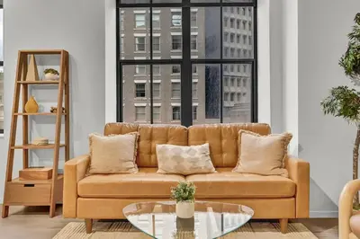 a living room with a couch and a glass table at Black & Tan Bold Style Smooth Finish Served Daily in Cleveland