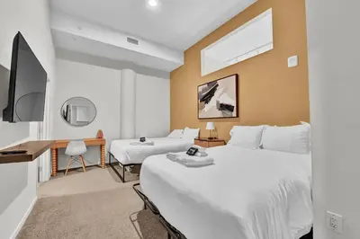 a hotel room with two beds and a flat screen tv at Black & Tan Bold Style Smooth Finish Served Daily in Cleveland