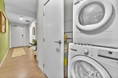 a laundry room with a washer and dryer at The Dirty Martini Den Classic style Extra Dirty in Cleveland