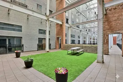 a courtyard with a bench in the middle of a building at Rhythm & Blues 2 BD Repose Near Rock & Roll HOF in Cleveland