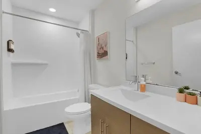 a white bathroom with a sink and a toilet at Soiree Vibes Bricks & Balcony 2Bx2B DT Cleveland in Cleveland