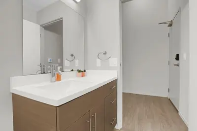 a bathroom with a white sink and a mirror at Soiree Vibes Bricks & Balcony 2Bx2B DT Cleveland in Cleveland