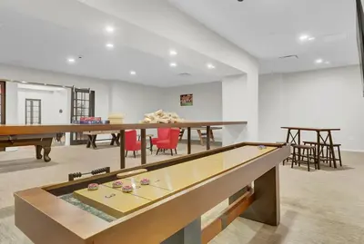a room with a ping pong table and some chairs at Soiree Vibes Bricks & Balcony 2Bx2B DT Cleveland in Cleveland