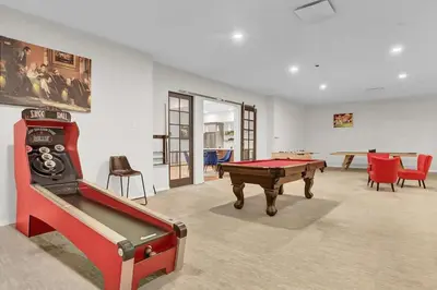 a room with a pool table and some chairs at Soiree Vibes Bricks & Balcony 2Bx2B DT Cleveland in Cleveland