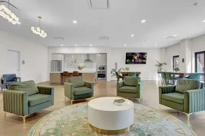 a living room with chairs and a table and a kitchen at Soiree Vibes Bricks & Balcony 2Bx2B DT Cleveland in Cleveland