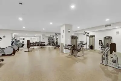 a gym with a lot of treadmills and machines at Billiards & Balcony 2Bx2B Rooftop It's Lit in Cleveland