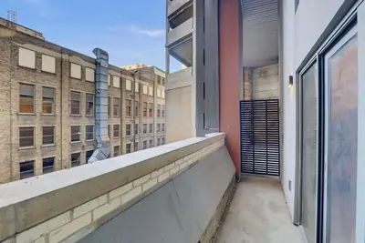 an apartment balcony with a view of buildings at Billiards & Balcony 2Bx2B Rooftop It's Lit in Cleveland