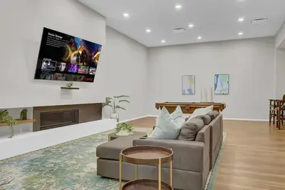 a living room with a couch and a tv at Billiards & Balcony 2Bx2B Rooftop It's Lit in Cleveland