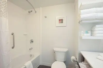 a white bathroom with a toilet and a bath tub at Hampton Inn & Suites - Cincinnati/Kenwood, OH in Cincinnati