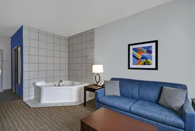 a living room with a couch and a bath tub at Holiday Inn Express Adrian by IHG in Adrian