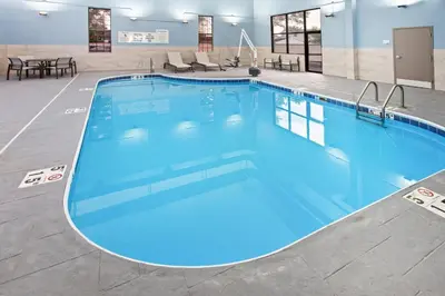 a large pool with blue water in a hotel room at Holiday Inn Express Cleveland Airport - Brook Park by IHG in Brook Park