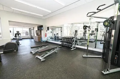 a gym with a lot of equipment in a room at Holiday Inn Cleveland-Mayfield by IHG in Mayfield