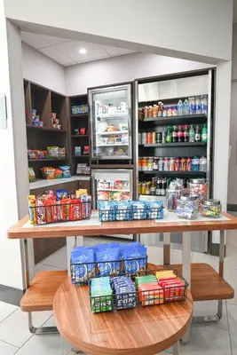 a table in a store with food and drinks at Holiday Inn Cleveland-Mayfield by IHG in Mayfield
