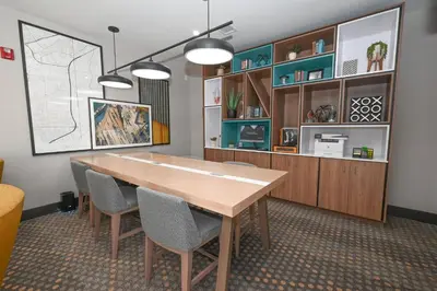 a dining room with a wooden table and chairs at Holiday Inn Cleveland-Mayfield by IHG in Mayfield