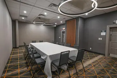 a conference room with a white table and chairs at Holiday Inn Cleveland-Mayfield by IHG in Mayfield
