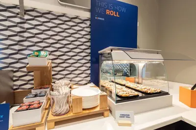 a display case with donuts and other pastries at Holiday Inn Express & Suites Dayton South - I-675 by IHG in Shanersville
