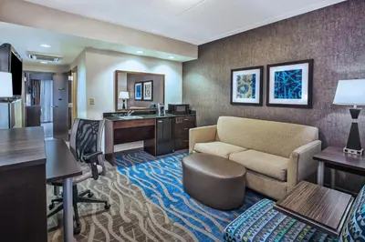 a hotel room with a couch and a desk at Holiday Inn Express & Suites Dayton South - I-675 by IHG in Shanersville