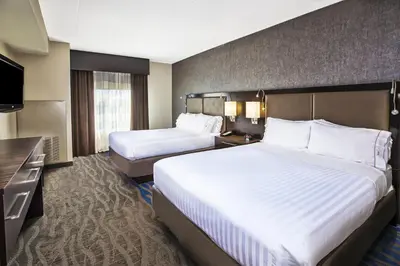 a hotel room with two beds and a television at Holiday Inn Express & Suites Dayton South - I-675 by IHG in Shanersville