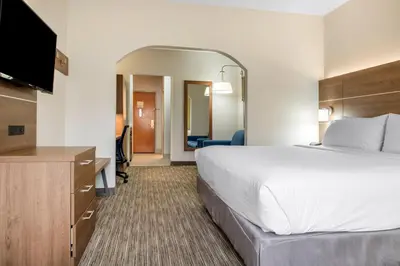 a hotel room with a bed and a flat screen tv at Holiday Inn Express & Suites Harrison by IHG in Harrison