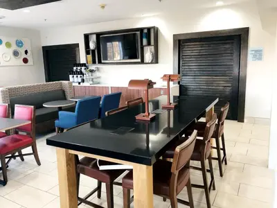 a dining room with a black table and chairs at Holiday Inn Express & Suites Harrison by IHG in Harrison