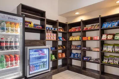 a refrigerator filled with lots of drinks in a store at Holiday Inn Express & Suites Harrison by IHG in Harrison