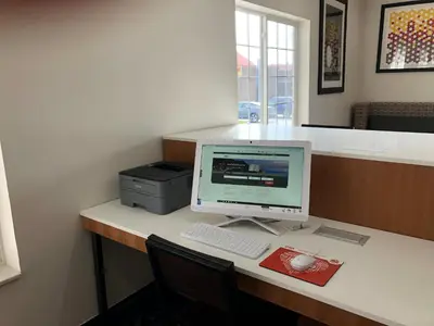 a desk with a computer monitor and a printer at Holiday Inn Express & Suites Harrison by IHG in Harrison