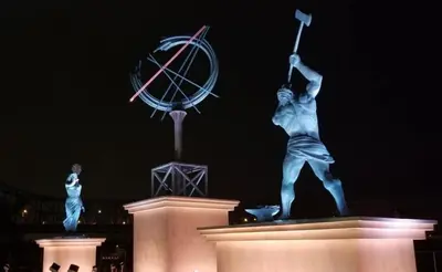 a statue of a man holding a wand and a clock at Holiday Inn Express & Suites Ironton by IHG in Ironton