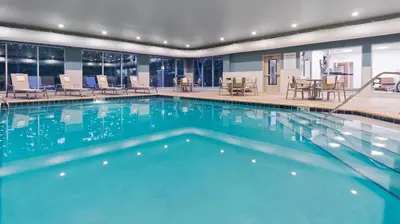 a swimming pool with blue water in a hotel at Holiday Inn Express & Suites Medina by IHG in Medina