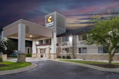 a hotel with a sign on the front of it at Comfort Inn & Suites Napoleon in Napoleon